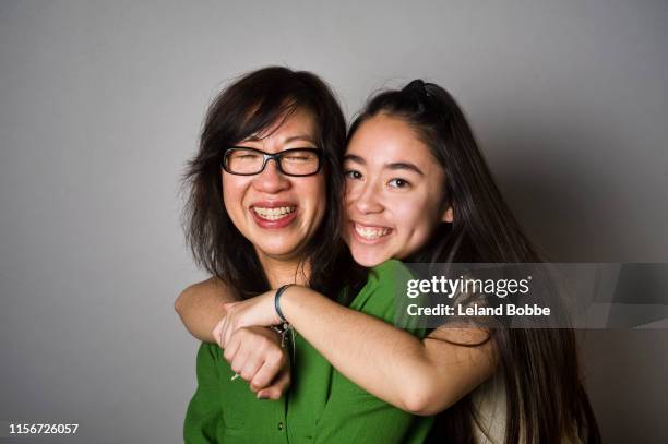 portrait of mother with mixed race teenage daughter - adolescent daughter mother portrait stock-fotos und bilder