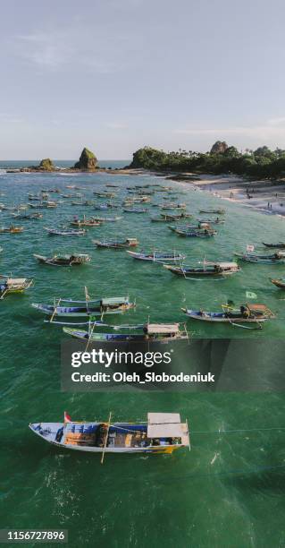 scenic aerial view of a lot of fishing boats in lagoon on java - indonesian culture stock pictures, royalty-free photos & images