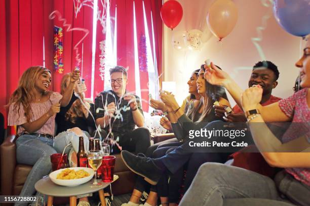 friends celebrating birthday at house party - college dorm party stock-fotos und bilder