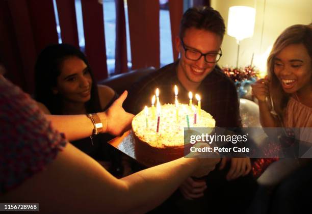 friends celebrating birthday at house party - milestones stock pictures, royalty-free photos & images