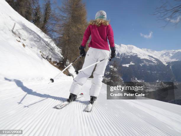 woman skiing down slope - ski pants stockfoto's en -beelden