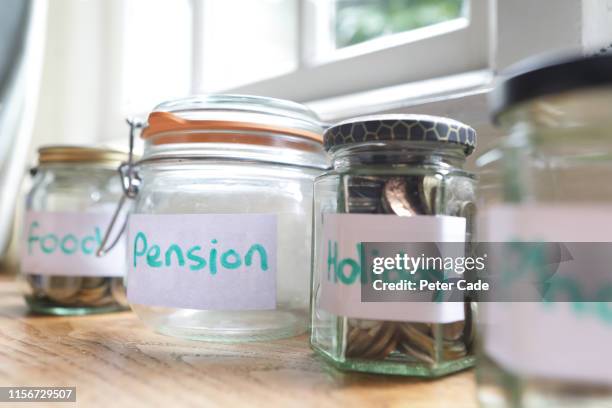 life event money jars - altersvorsorge stock-fotos und bilder