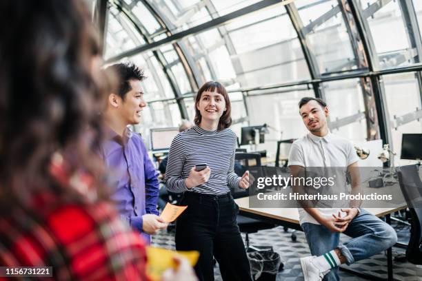 team leaders talking with each other during meeting - office excitement stock pictures, royalty-free photos & images