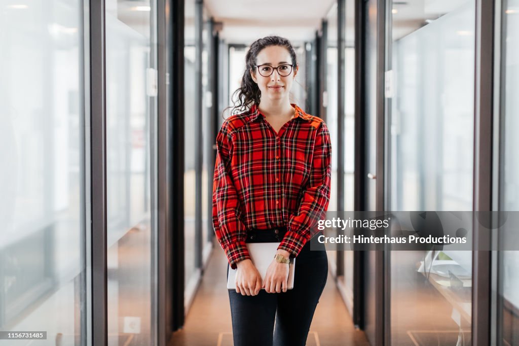 Portrait Of Business Employee Holding Digital Tablet