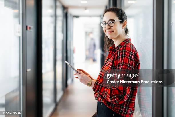 portrait of office employee leaning on window - red plaid stock pictures, royalty-free photos & images