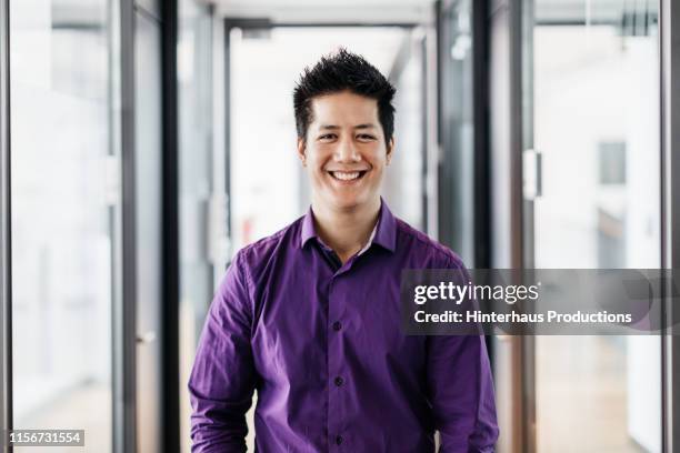 portrait of office employee smiling - purple shirt stock pictures, royalty-free photos & images