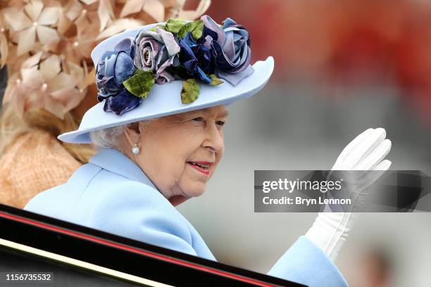 Queen Elizabeth II waves to the crowds as she arrives on day one of Royal Ascot at Ascot Racecourse on June 18, 2019 in Ascot, England.