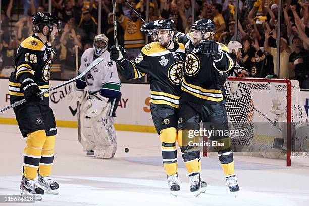 Michael Ryder of the Boston Bruins celebrates with his teammates Chris Kelly and Tyler Seguin after scoring a goal in the second period against...