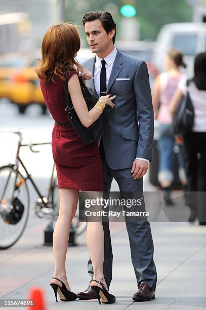 Actors Hilarie Burton and Matt Bomer film a scene on the "White Collar" film set in Midtown Manhattan on June 8, 2011 in New York City.