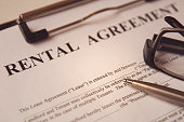 Business legal document concept : Pen and glasses on a rental agreement form.