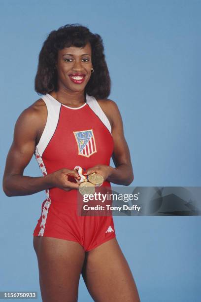 Jackie Joyner-Kersee of the United States poses for a portrait with her gold medals for winning gold in the Women's Long Jump and Heptathlon during...