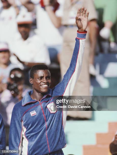 Carl Lewis of the United States stands on the podium to receive his gold medal for winning the Men's 4 x 100m relay metres event at the XXIII Olympic...