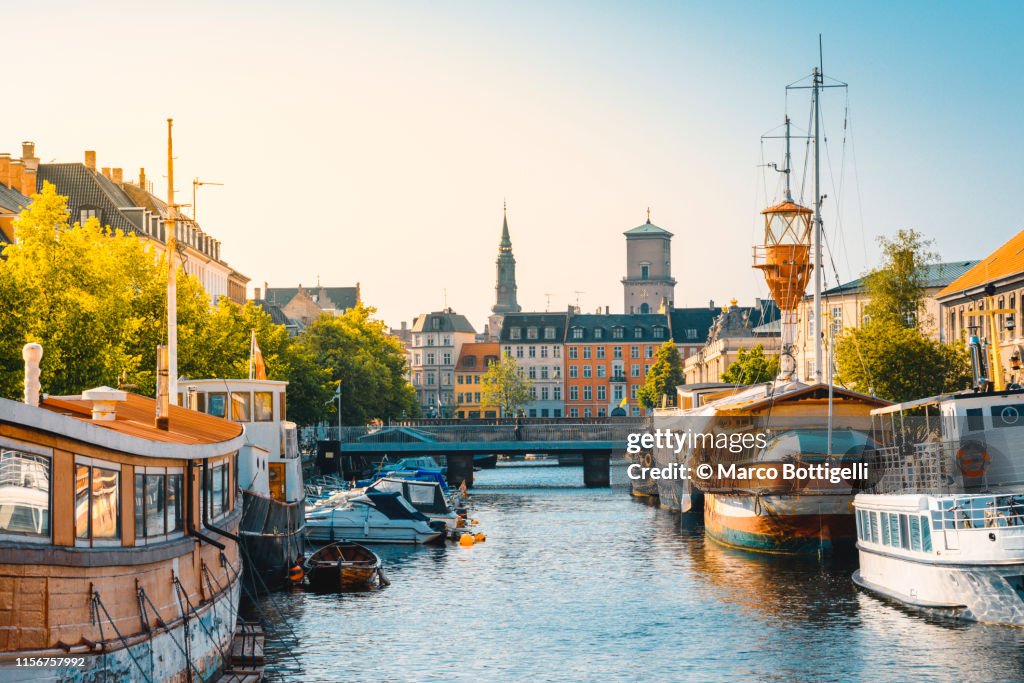 Moored boats along a narrow canal in Copenhagen old town, Denmark