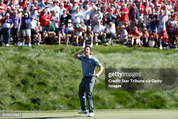 Golfer, Rory McIlroy taunts the gallery to make some noise after sinking a long birdie putt on the 8th hole during match play against USA player,...