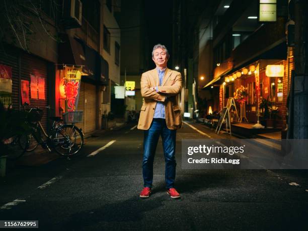 japanese senior man portrait at night - dark street stock pictures, royalty-free photos & images