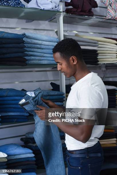 Man selecting a pair of jeans