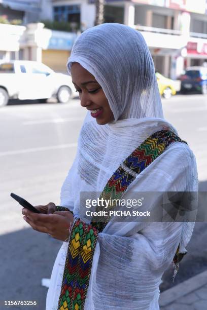 Woman using her phone in the street