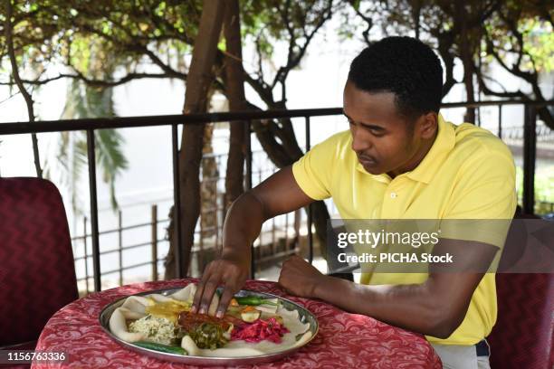 Man having Ethiopian food