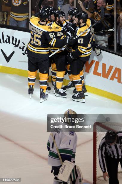 Rich Peverley of the Boston Bruins celebrates with his teammates Milan Lucic, Johnny Boychuk, David Krejci and Andrew Ference after scoring goal in...