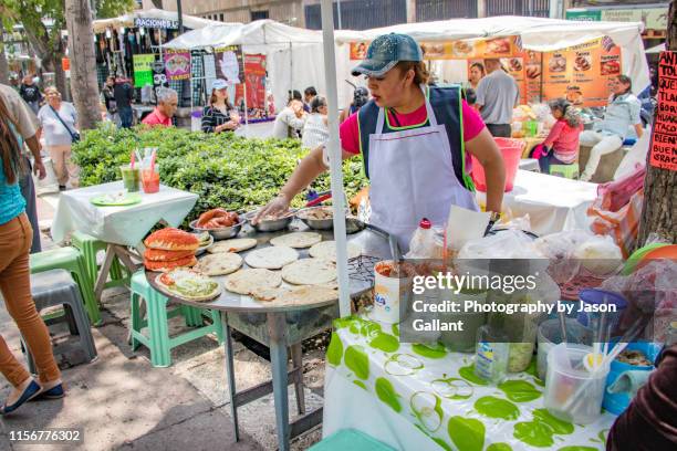 woman cooking mexican food in a weekend market in alameda central park in mexico city. - mexican street market stock pictures, royalty-free photos & images