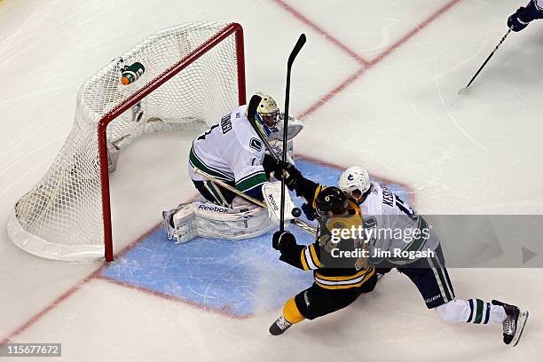 Rich Peverley of the Boston Bruins scores a goal in the third period against Roberto Luongo of the Vancouver Canucks during Game Four of the 2011 NHL...