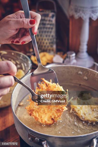 preparing rosti potato pancake in domestic kitchen - baked sweet potato stock pictures, royalty-free photos & images