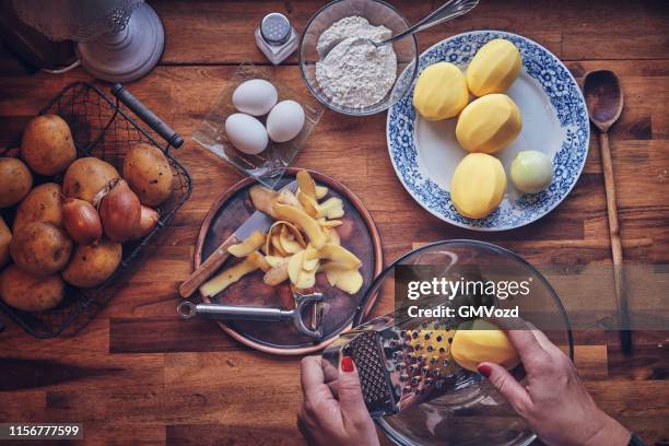 preparing rosti potato pancake in domestic kitchen - potato pancake stock pictures, royalty-free photos & images