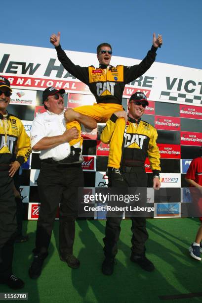 Bill Davis Racing driver Ward Burton is being lifted up by Bill Davis and Tommy Baldwin Jr. In victory circle after taking his Dodge Intrepid R/T to...