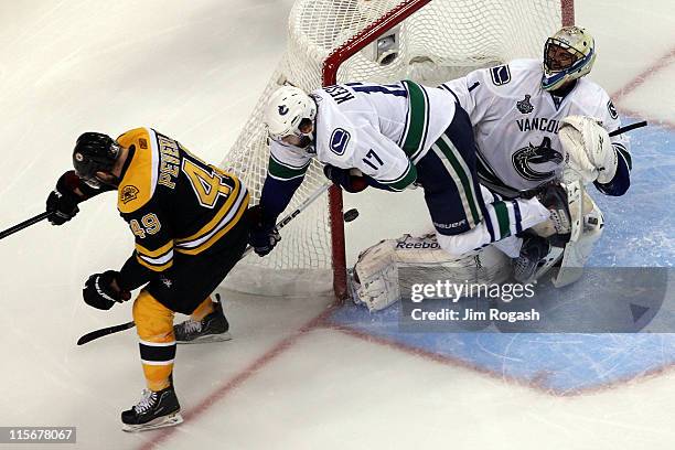 Rich Peverley of the Boston Bruins scores a goal in the third period against Roberto Luongo of the Vancouver Canucks during Game Four of the 2011 NHL...