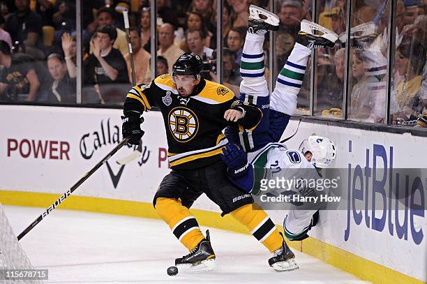 Brad Marchand of the Boston Bruins dodges Daniel Sedin of the Vancouver Canucks during Game Four of the 2011 NHL Stanley Cup Final at TD Garden on...