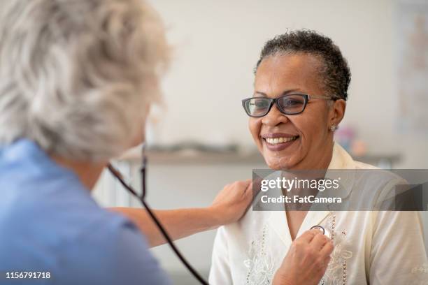 checking a heart beat - listening to heartbeat stock pictures, royalty-free photos & images