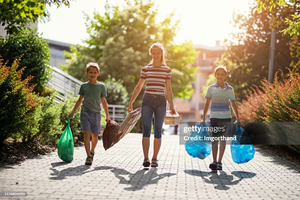 Kids taking out the segregated garbage