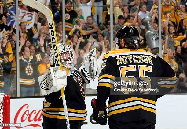 Johnny Boychuk and goaltender Tim Thomas of the Boston Bruins celebrate their 4-0 victory over the Vancouver Canucks in Game Four of the 2011 NHL...