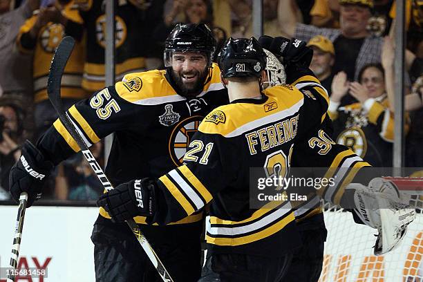 Tim Thomas of the Boston Bruins celebrates with his teammates Johnny Boychuk and Andrew Ference after defeating the Vancouver Canucks in Game Four of...