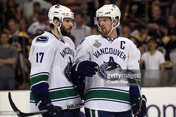 Ryan Kesler of the Vancouver Canucks talks with teammate Henrik Sedin during Game Four against the Boston Bruins in the 2011 NHL Stanley Cup Final at...