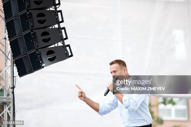 Russian opposition leader Alexei Navalny addresses demonstrators during a rally to support opposition and independent candidates after authorities...