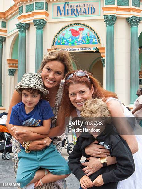 In this handout image provided by Disney Parks, Mariska Hargitay and her son August join Debra Messing and her son, Roman at the new attraction, 'The...