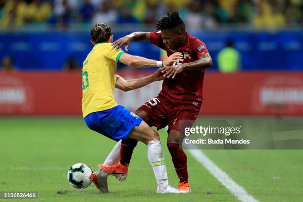 Jhon Murillo of Venezuela fights for the ball with Filipe Luis of Brazil during the Copa America Brazil 2019 group A match between Brazil and...