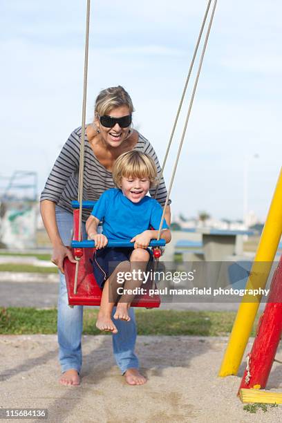 mother and son at playground - mother and son at playground stock-fotos und bilder