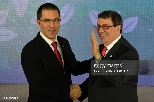 Venezuelan Foreign Minister Jorge Arreaza greets his Cuban counterpart Bruno Rodríguez upon arrival at a hotel for the opening ceremony of the...