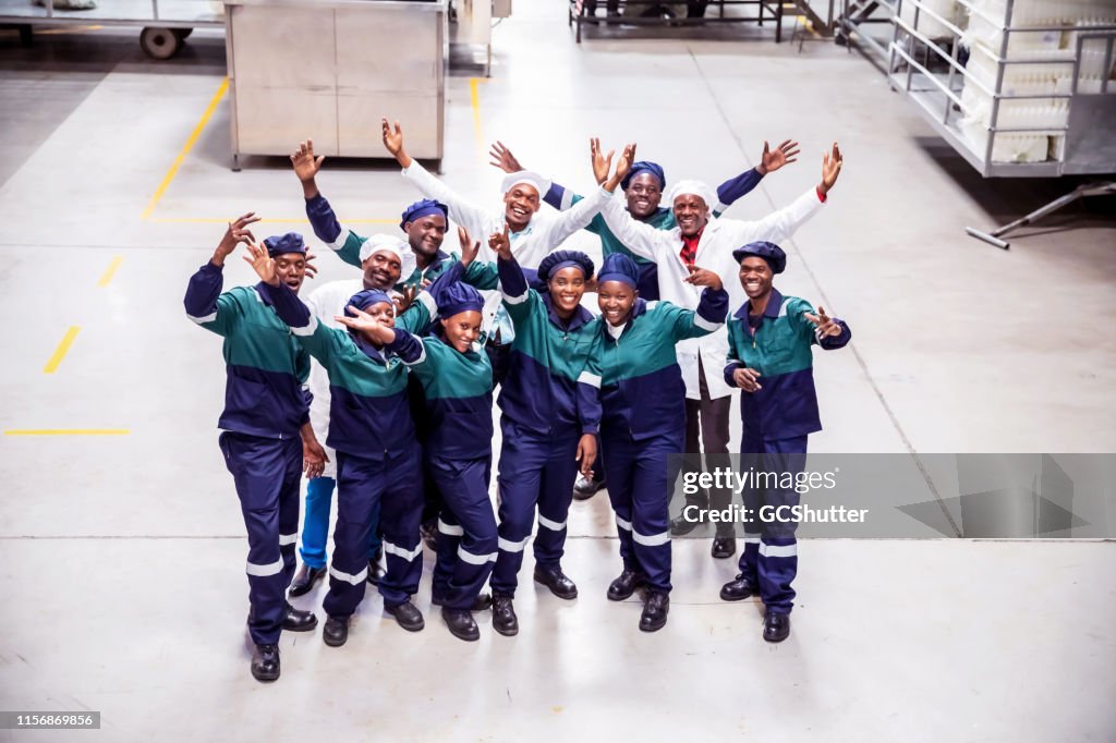 Workman Cheering Group Of Factory Workers Cheering Togetherness High-Res Stock Photo ...