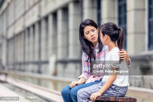 a mother having a serious talk with her daughter - serious child stock pictures, royalty-free photos & images