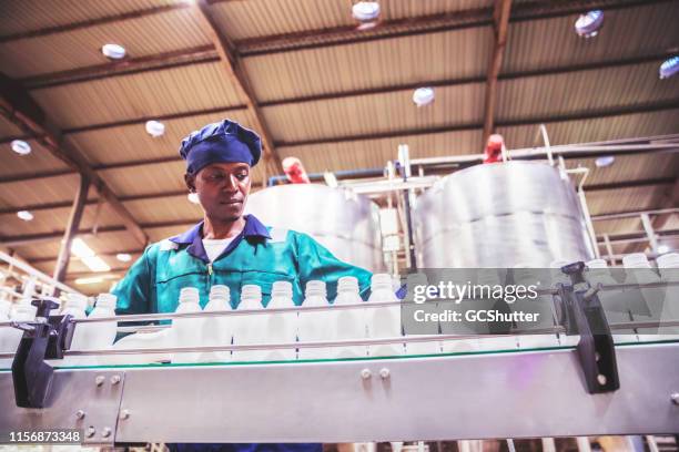 production line worker at a dairy plant in africa - dairy factory stock pictures, royalty-free photos & images