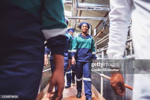 group of factory staff arriving to their work shift - africa - dairy factory worker stock pictures, royalty-free photos & images