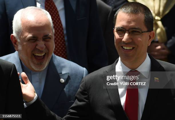 Irani's Foreign Minister Mohammad Javad Zarif and Venezuela's Jorge Arreaza laugh during the family photo of the Ministerial Meeting of the...