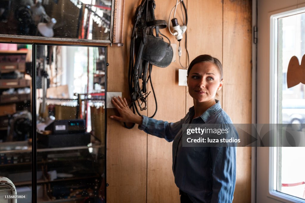 Young female entrepreneur working at her small workshop business