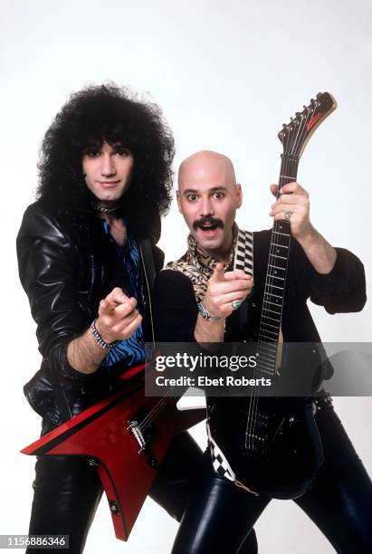 Bruce and Bob Kulick, studio portrait in New York City on May 7, 1985. Bob Kulick is holding a Washburn G-35V guitar.