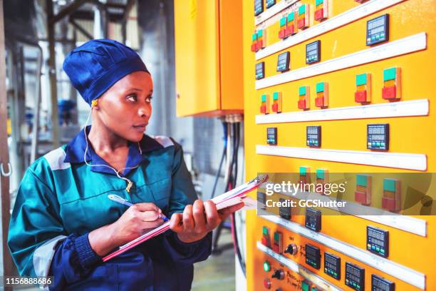 female factory engineer checking the electrical panel - third world stock pictures, royalty-free photos & images