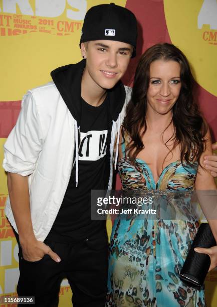 Justin Bieber and Pattie Mallette attend the 2011 CMT Music Awards at the Bridgestone Arena on June 8, 2011 in Nashville, Tennessee.