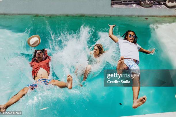 three friends falling backwards into swimming pool - friends smile bildbanksfoton och bilder